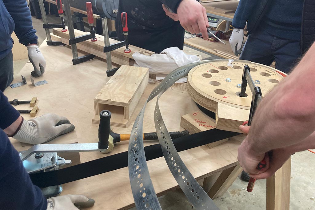 Steam bending course: Team using the steam bending jig to make Sussex Mirror